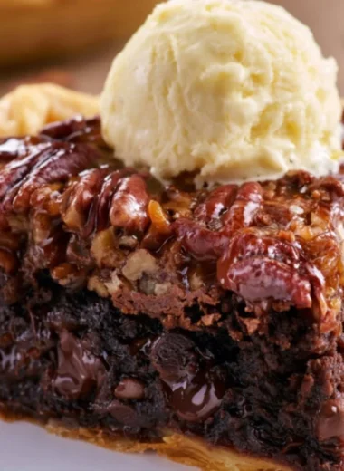 Delicious Brownie Pecan Pie with chocolate and pecans served on a plate.