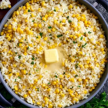 Delicious buttered corn rice served in a bowl with fresh herbs