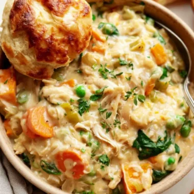 Cozy crustless chicken pot pie served in a bowl with fresh herbs on top