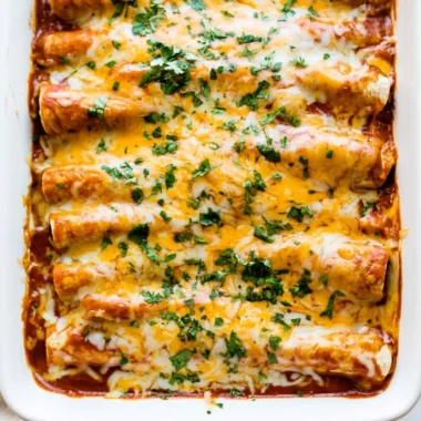 Delicious easy chicken enchiladas topped with cheese and fresh ingredients