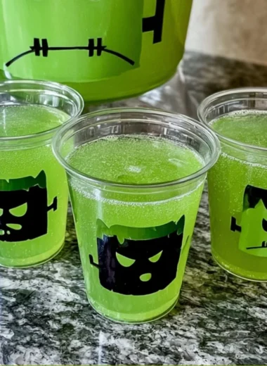 Frankenstein Green Punch cocktail in a spooky Halloween setting.