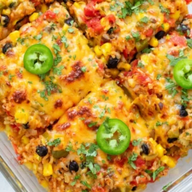 Healthy vegetarian rice and bean casserole baked in a dish, full of colorful vegetables.