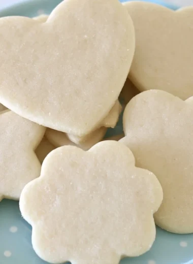 Freshly baked perfect sugar cookies on a cooling rack.