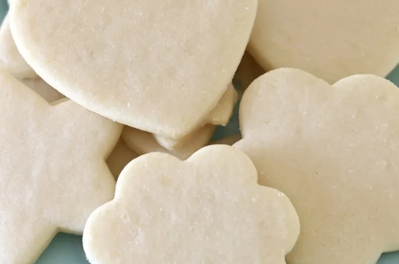 Freshly baked perfect sugar cookies on a cooling rack.