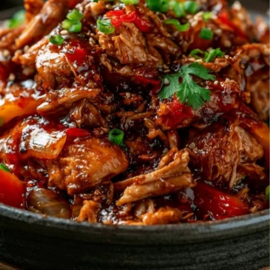 Slow Cooker Sweet Chili Chicken served on a plate with fresh herbs