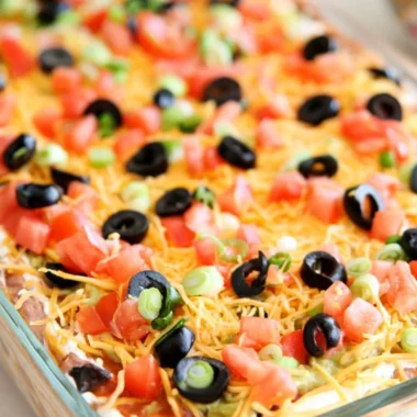 Delicious Ultimate Seven Layer Bean Dip served in a colorful dish.