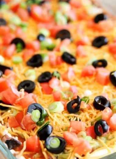 Delicious Ultimate Seven Layer Bean Dip served in a colorful dish.