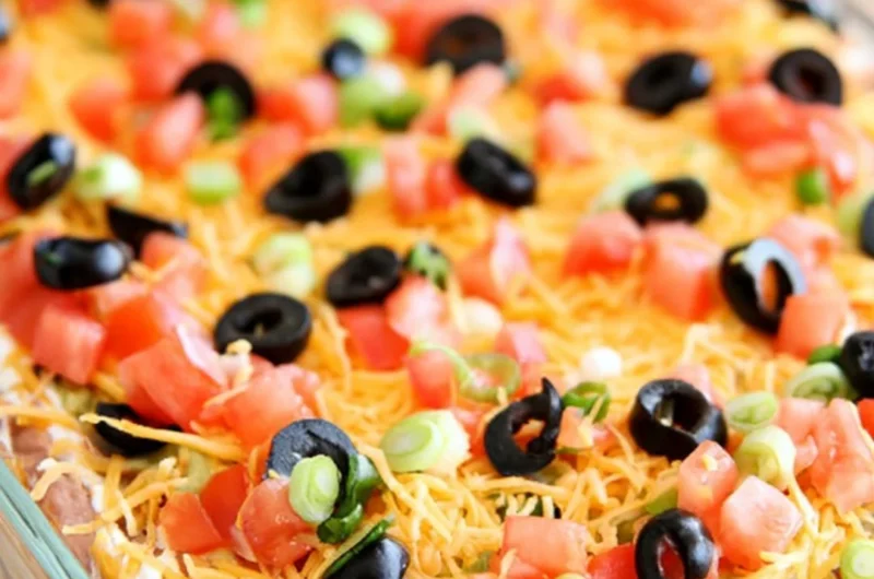 Delicious Ultimate Seven Layer Bean Dip served in a colorful dish.