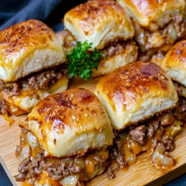 Cheeseburger sliders made with Hawaiian rolls on a platter.