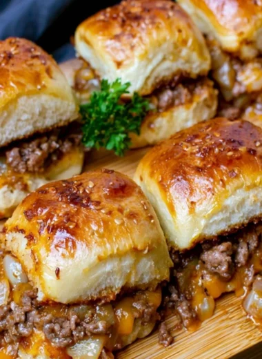 Cheeseburger sliders made with Hawaiian rolls on a platter.