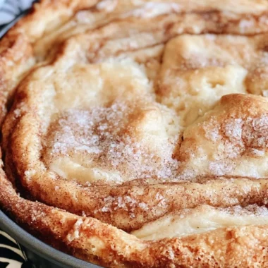 Delicious slice of Cinnamon Swirl Coffee Cake on a plate with coffee