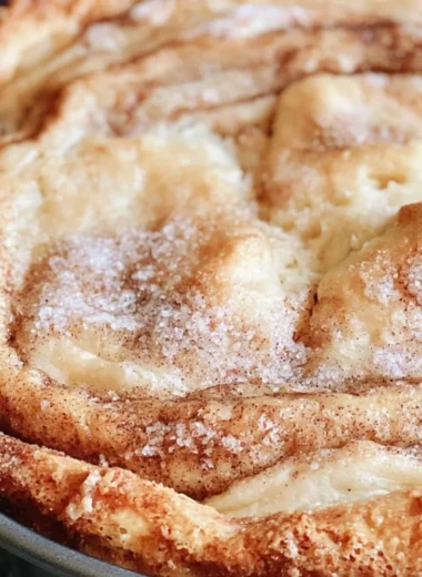 Delicious slice of Cinnamon Swirl Coffee Cake on a plate with coffee