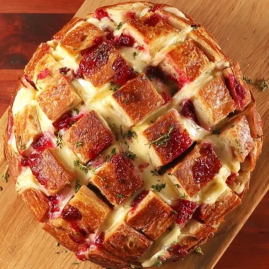 Cranberry Brie Pull-Apart Bread fresh out of the oven with cranberry sauce and melted cheese.