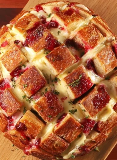 Cranberry Brie Pull-Apart Bread fresh out of the oven with cranberry sauce and melted cheese.