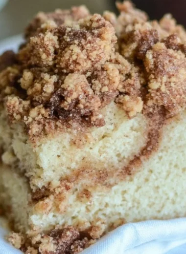 Delicious cinnamon coffee cake sliced on a plate, perfect for breakfast.