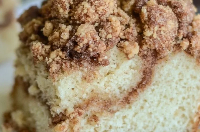 Delicious cinnamon coffee cake sliced on a plate, perfect for breakfast.