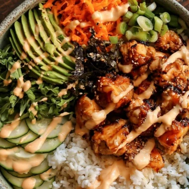 Delicious Sticky Honey Ginger Chicken Bowls served in a vibrant bowl.