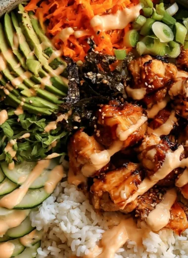 Delicious Sticky Honey Ginger Chicken Bowls served in a vibrant bowl.